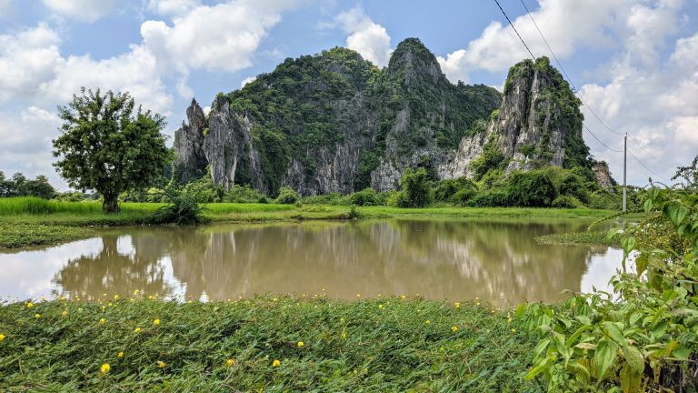 Turquoise pools framed by jagged limestone cliffs at Kampong Trach.