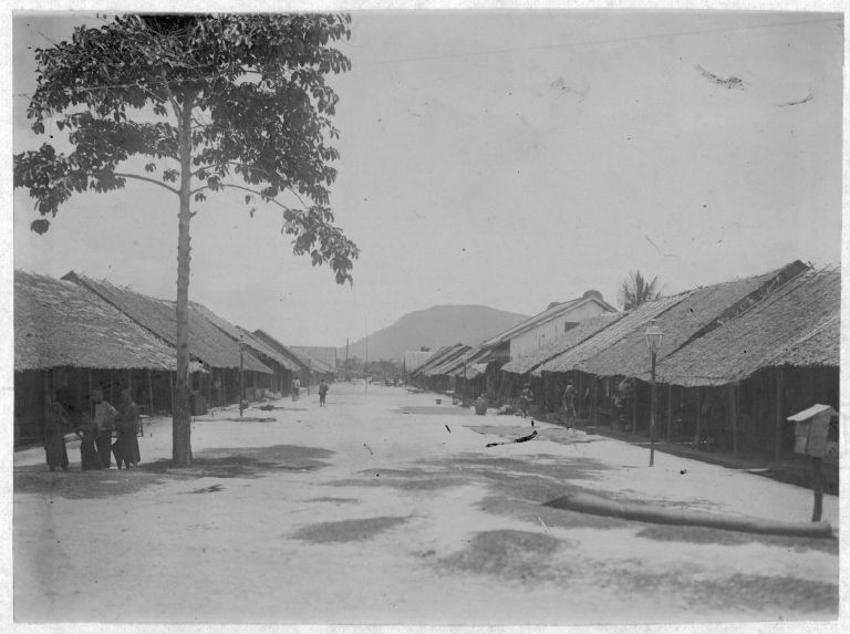 A street in early colonial Kampot, the Elephant Mountains rising on the horizon
