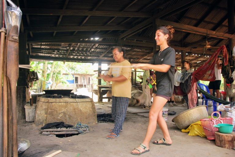 Aerating and cooling palm sugar syrup on a farm near Kampot